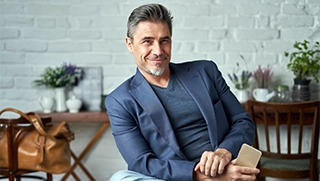 white man in jacket sitting in living room