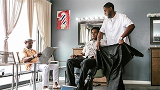 barber shop business owner in Florida working with clientele