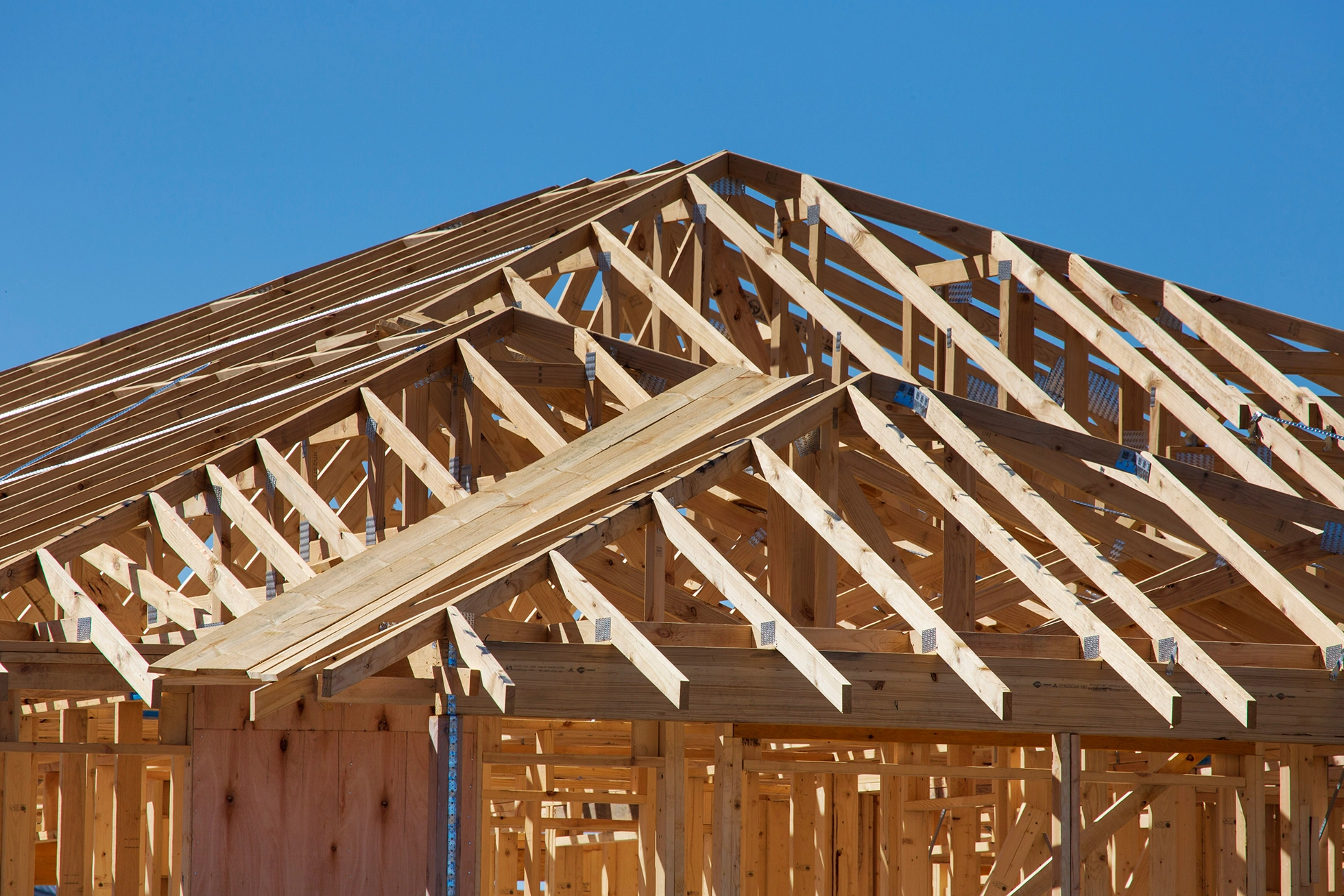 Florida new home construction in the framing stage, bright blue sky in background