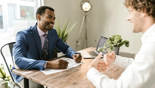 african american independent insurance agent in blue suit meeting with business owner in office environment african american independent insurance agent in blue suit meeting with business owner in office environment