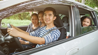 family of four smiling in their car with affordable car insurance family of four smiling in their car with affordable car insurance