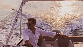 man driving boat at sunset off the Florida coast