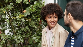 young black woman with curly hair talking to white man about renters insurance in Florida