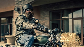 Florida man with beard on motorcycle covered by affordable insurance policy