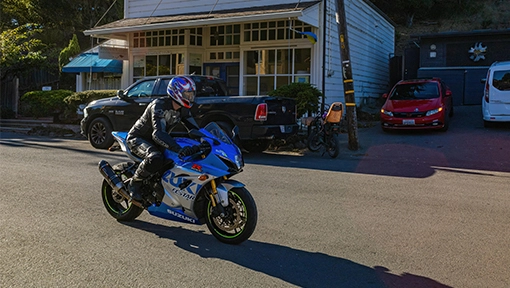 blue motorcycle riding through local Florida street with businesses